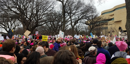 WASHINGTON, DC - JANUARY 21, 2017: Protesters hold up anti-Trump signs as thousands participate in the Women's March on Washington for social justice, the day after the Presidential Inauguration.のeditorial素材