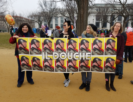 WASHINGTON, DC - JANUARY 21, 2017: Protesters hold up anti-Trump signs as thousands participate in the Women's March on Washington for social justice, the day after the Presidential Inauguration.のeditorial素材