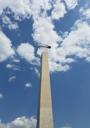 A funny, squid-shaped kite at the Kite Festival on the National Mall, flying close to the Washington Monument during the Cherry Blossom Festival.の写真素材
