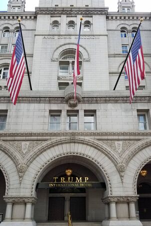 Washington DC, USA - September 29, 2019: Trump International Hotel entrance with the American flags and the statue of Benjamin Franklin, situated in the Old Post Office Tower historical building.のeditorial素材