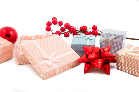Gift packages and Christmas-colored accessories isolated on white