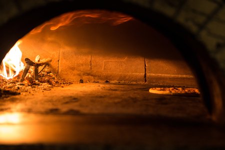 Pizza cooking in the oven to traditionの写真素材
