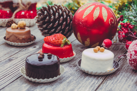An array of Christmas desserts with colorful, on wooden boardの写真素材