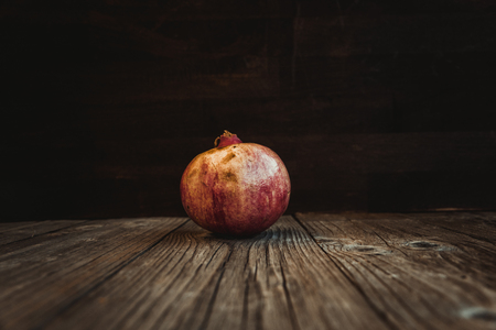 Pomegranate. Fresh raw fruit on a wooden boardの写真素材