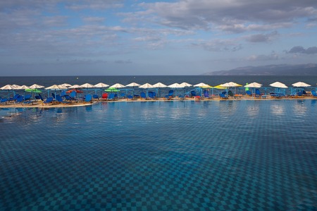 Swimming pool with chaise lounges and umbrellasの写真素材