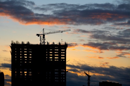 Construction of a building on a decline and the building craneの写真素材