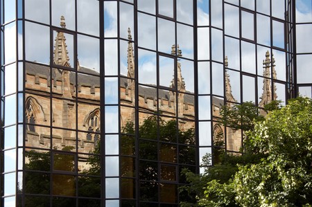 Glasgow. Reflection of an ancient church in a modern glass building