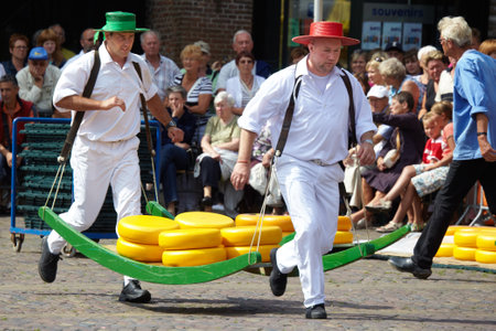 Cheese festival in city Alkmaar - the Netherlands Sale  of cheese roll porters on a stretcher   14 08 2009のeditorial素材