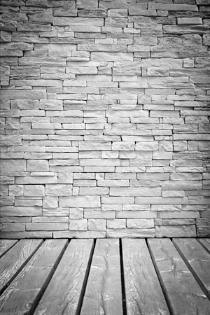 Vignette Light loft wall of stone blocks with a With wood flooring surface as a backgroundの写真素材