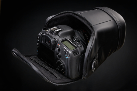 Black DSLR camera isolated on a black backgroundの写真素材