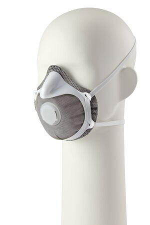 Protective medical mask on a mannequin head isolated on a white backgroundの写真素材