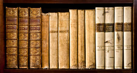 Ancient books (XVI and XVII century) on a wood shelfの写真素材