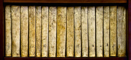 ancient books (XVI century) on a wood shelfの写真素材
