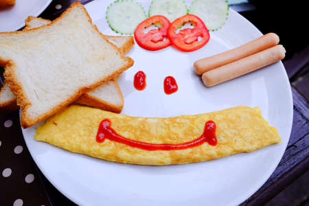 Breakfast set with omelet, sausage and breadの写真素材