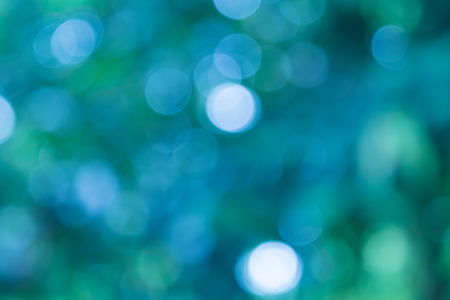 blue natural background of out of focus forest or bokehの写真素材