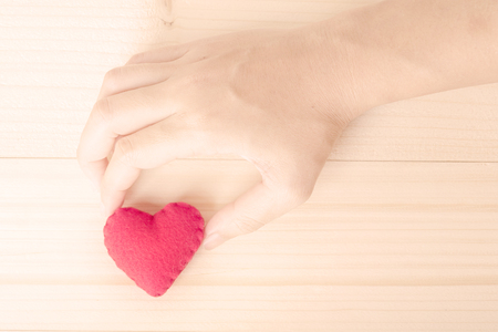 woman holding love heart object in hand for valentine dayの写真素材