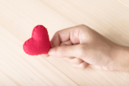 Female hands giving red heartの写真素材