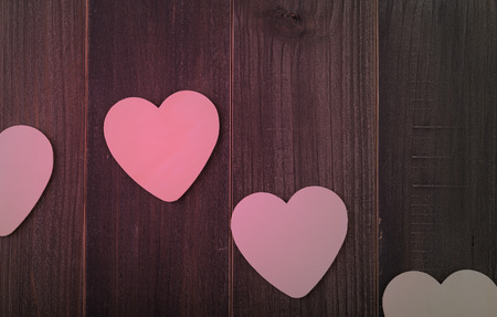 Beautiful paper hearts on wood backgroundの写真素材