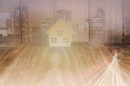 Sweet home model on wood background with overlay civilization city conceptの写真素材