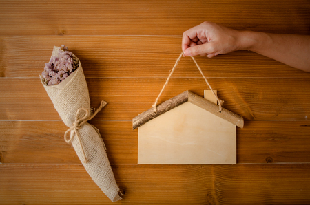 Wood home flower and handの写真素材