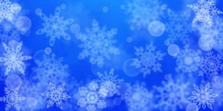 Christmas background of blurry snowflakes in blue colors