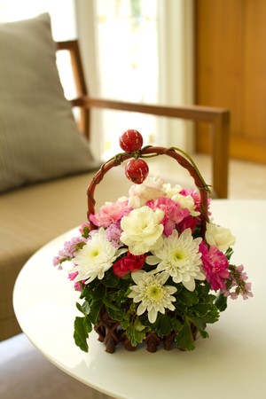 Flower basket on coffee tableの写真素材