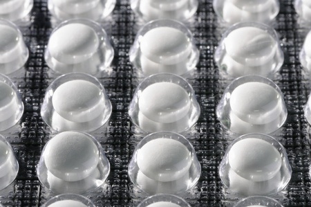 White tablets of medication in a blister package.の写真素材