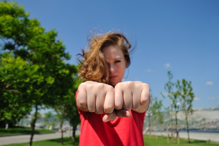 Girl with fists. choose a fist game.の写真素材