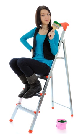 The girl-house painter on a step-ladder. On a white background.の写真素材
