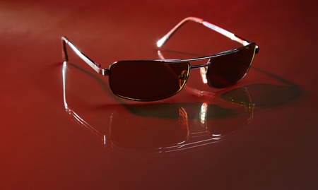 Sunglasses on red background