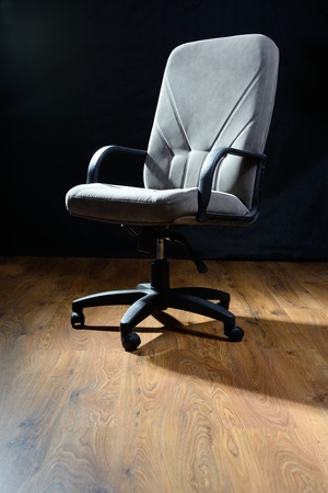 Gray armchair on wooden floor.の写真素材