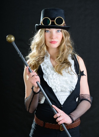 Steampunk female with a cane, top hat and goggles.の写真素材