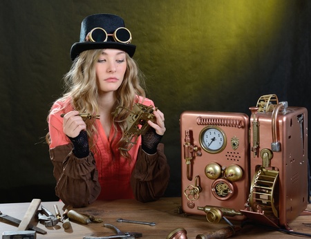 Steam punk girl repairing Phone. Telephone - Hand/home made model.の写真素材