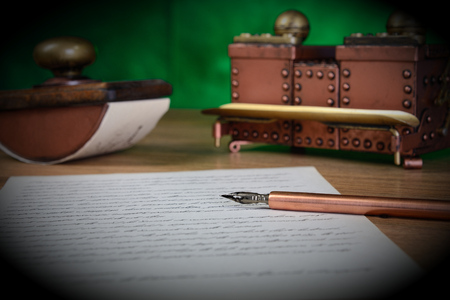 Paper, ink pen, inkstand and paperweight on the table. Low depth of field.の写真素材