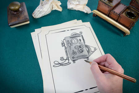 Man makes a sketch drawing of the phone. Hand with a pen drawsの写真素材