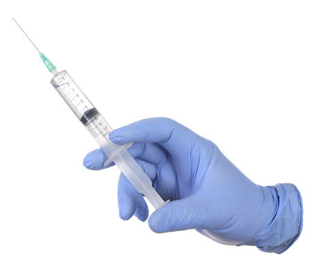 Hand in medical blue glove holding syringe. Isolated on white.の写真素材