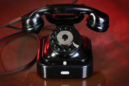 Old black telephone on red background. Retro-styleの写真素材