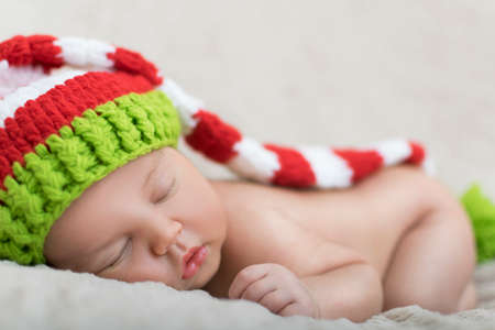 sleeping newborn baby in a wrapの写真素材