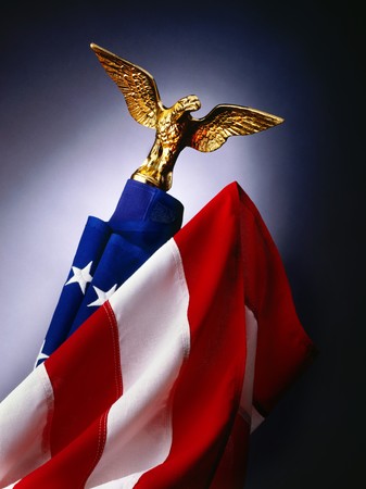 American flag with gold eagle on flagpoleの写真素材