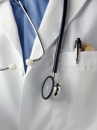 Close up shot of wearing lab coat, with stethoscope, pen light and tongue depressorsの写真素材