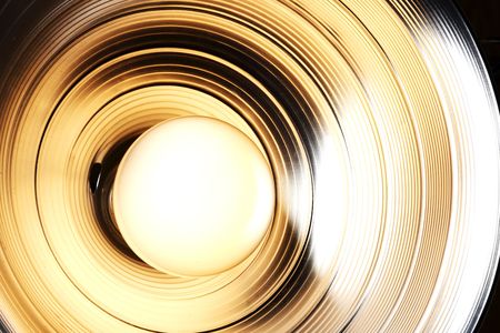 incandescent light bulb aglow in a reflectorの写真素材