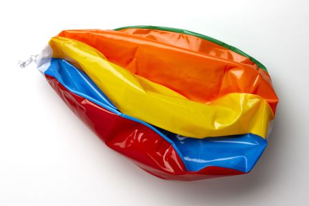 colorful deflated beach ball shot on white backgroundの写真素材