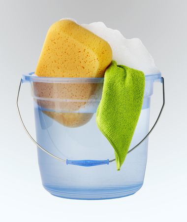 Bucket of water, soap suds, sponge and towelの写真素材
