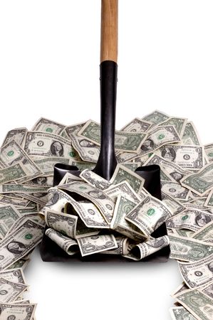 Shovel clears a path thru a pile of dollar billsの写真素材