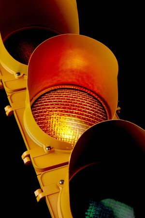 Close up of traffic light with illuminated amber lensの写真素材