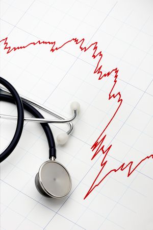 Sharply declining stock chart with stethoscope at the readyの写真素材