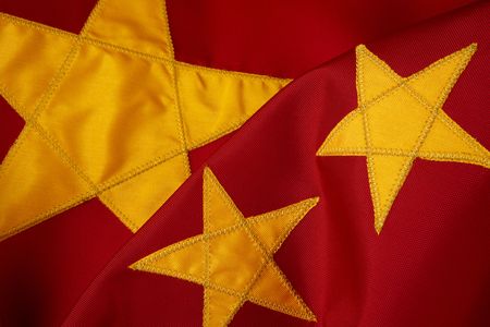 Close-up shot of yellow stars on wavy chinese flagの写真素材