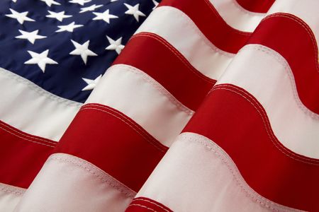 macro shot of wavy American flag with foreground stripes in focus and soft  stars background