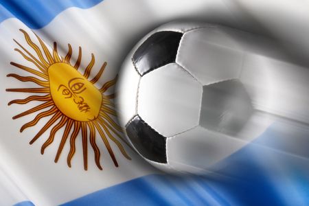 Soccer ball streaks across flag of Argentinaの写真素材