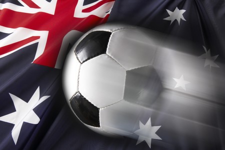 Soccer ball streaks across flag of Australiaの写真素材